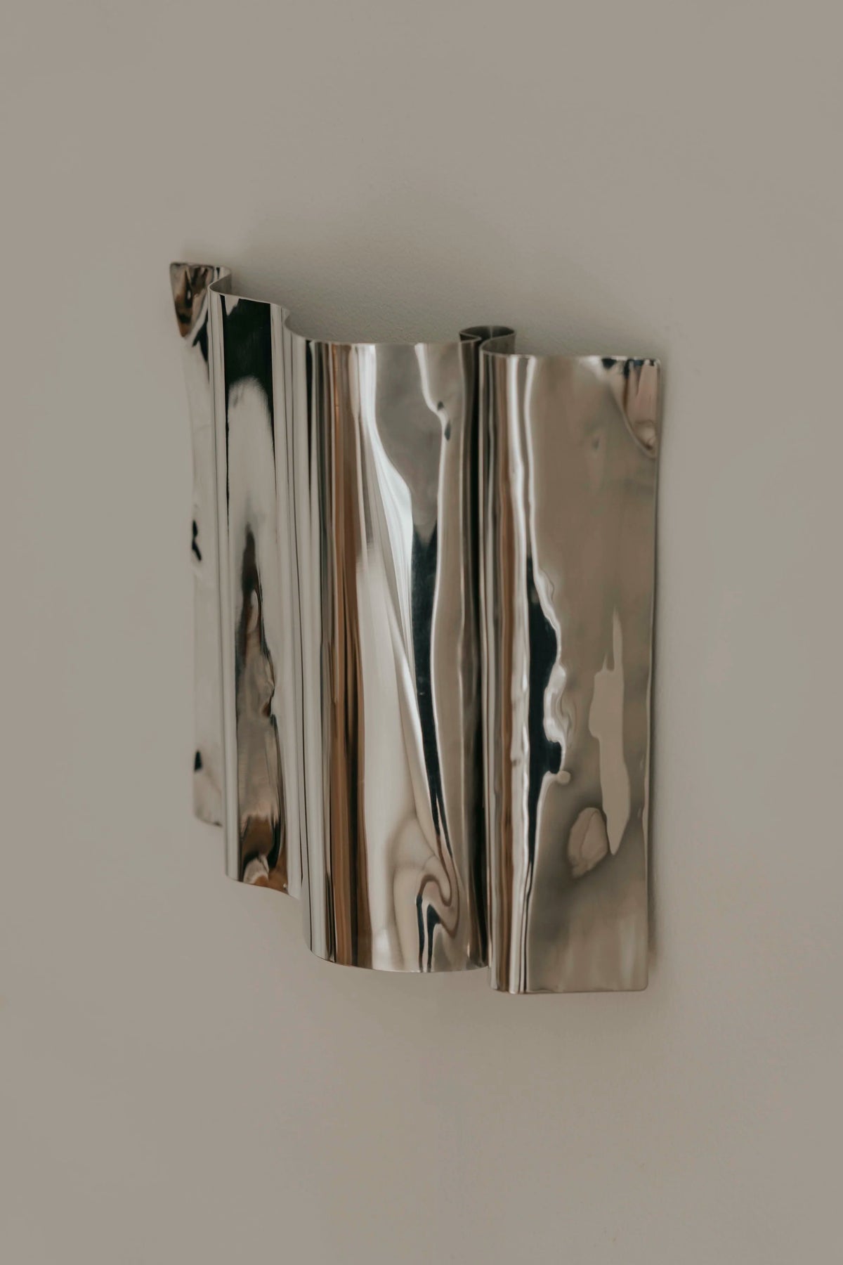 Psychedelic Wall Sconce — close-up detail of polished stainless steel