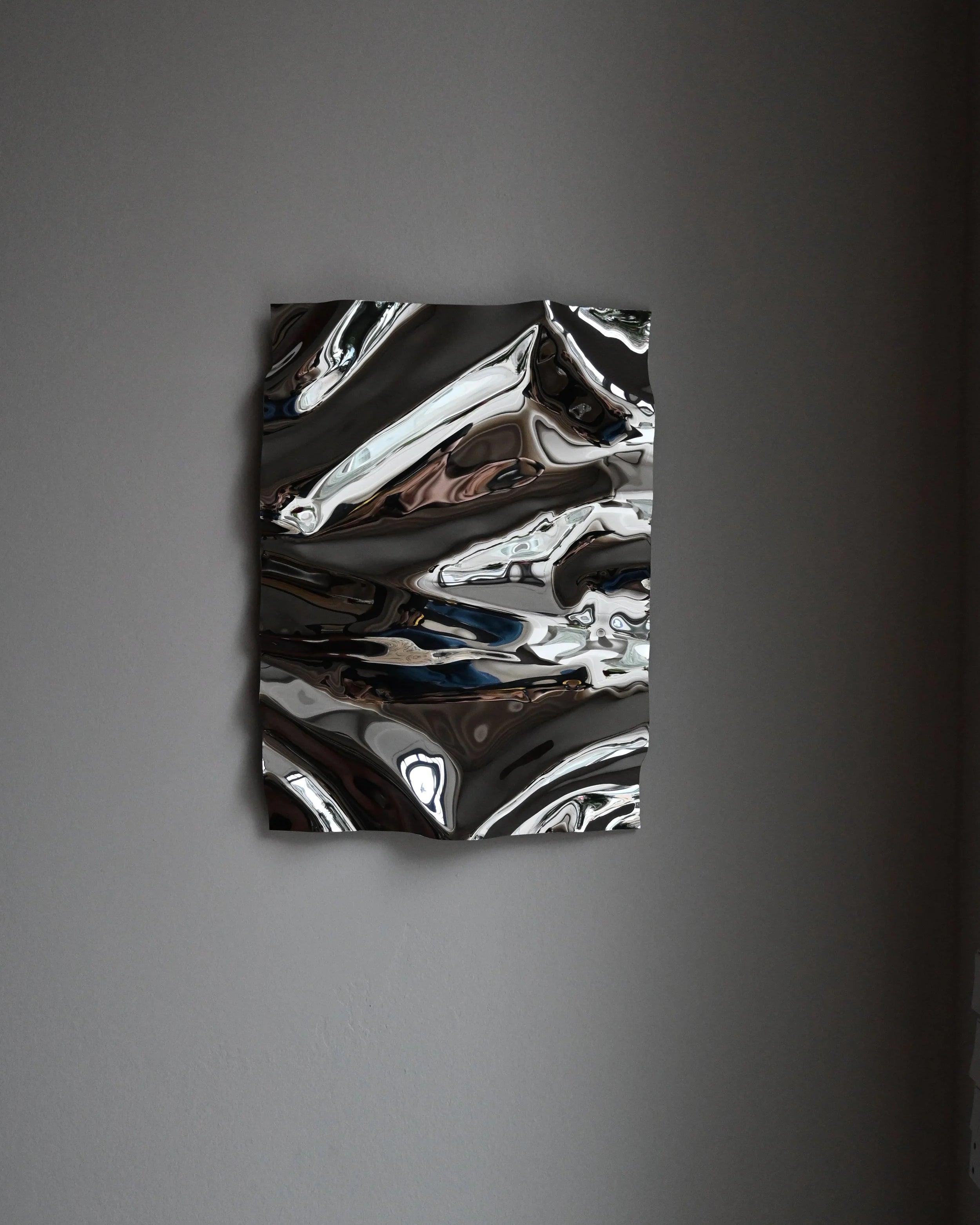 Psychedelic Mirror 35*50 cm by Caia Leifsdotter — hand-shaped polished steel, front view