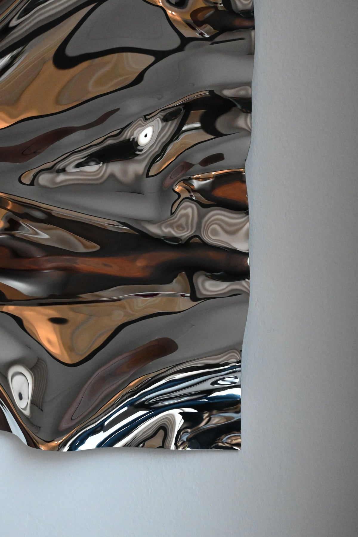 Psychedelic Mirror 35*50 cm — hand-shaped polished steel, angle view showing craftsmanship