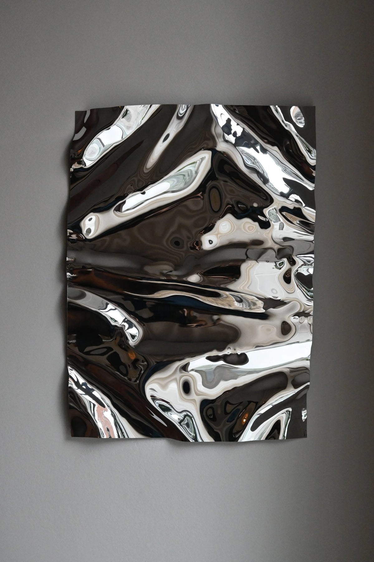 Psychedelic Mirror 50*70 cm by Caia Leifsdotter — hand-shaped polished steel, front view
