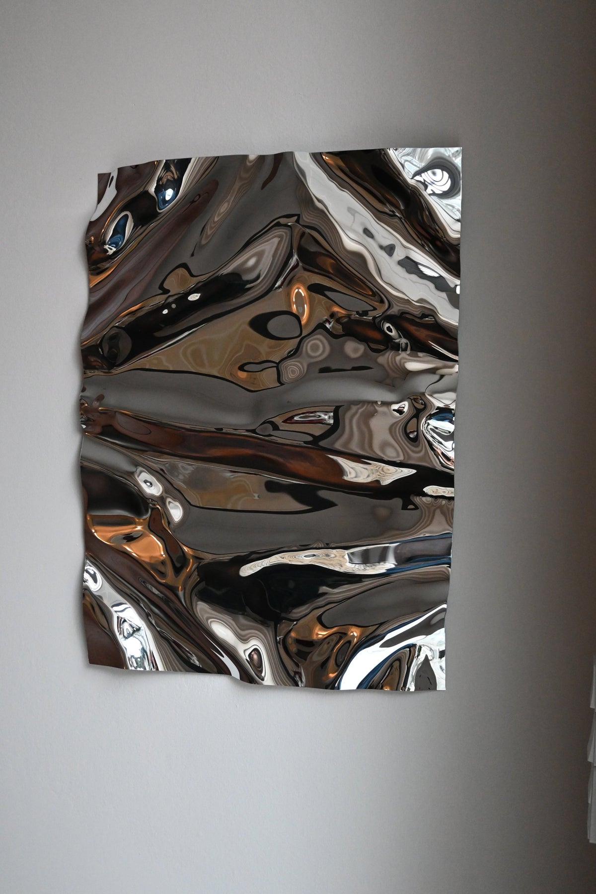 Psychedelic Mirror 50*70 cm — hand-shaped polished steel, angle view showing craftsmanship