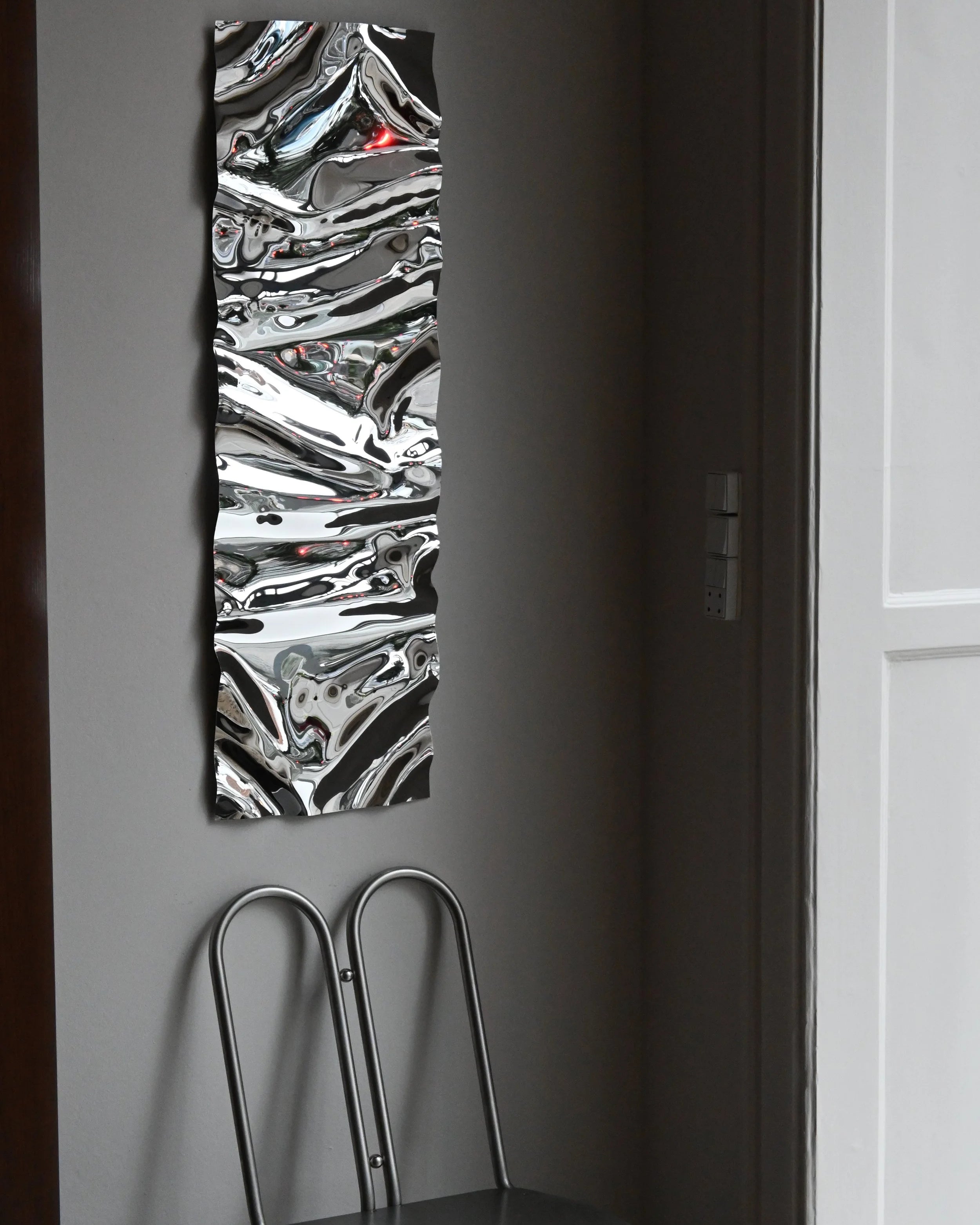 Psychedelic Mirror 30*100 cm by Caia Leifsdotter — hand-shaped polished steel, front view