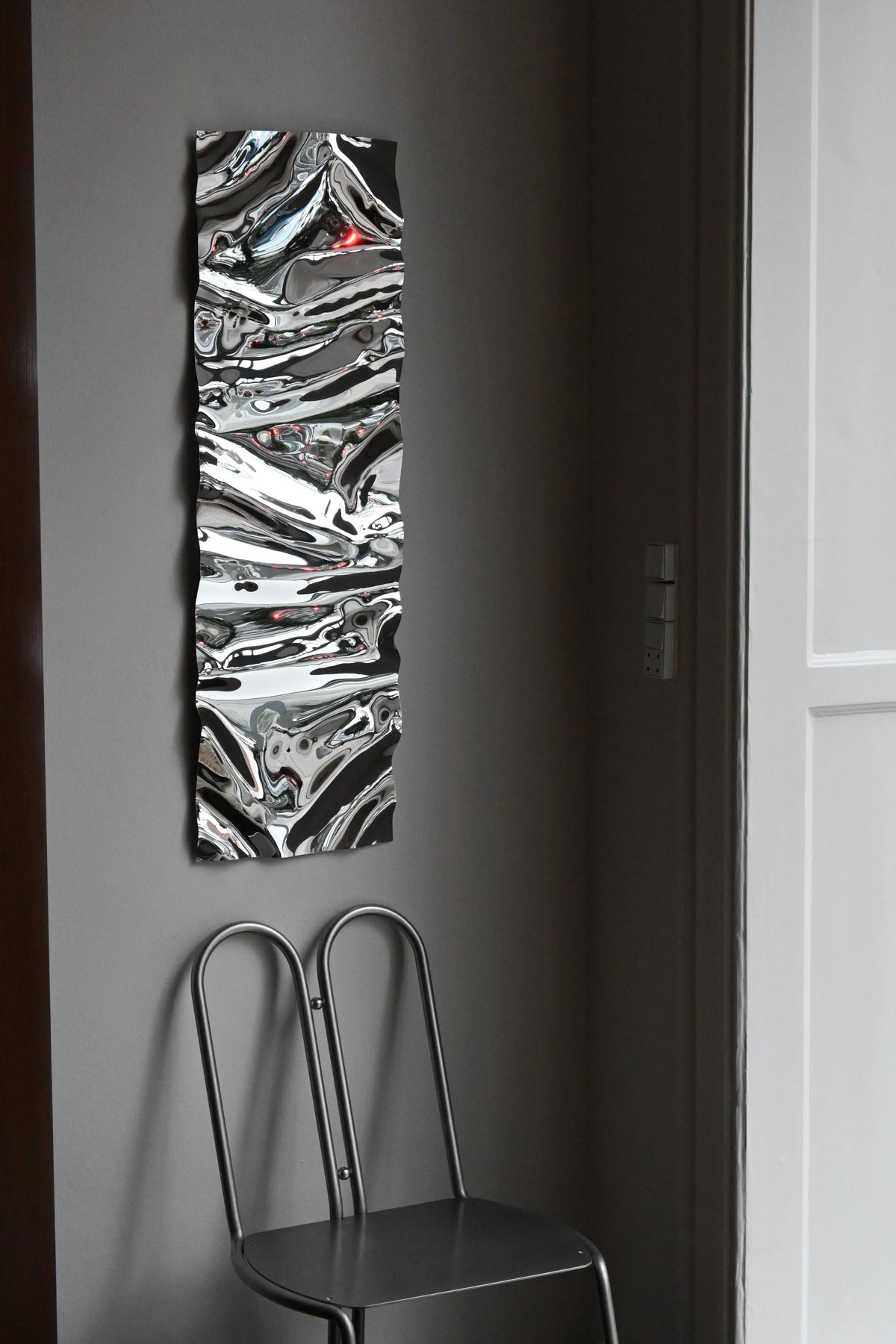 Psychedelic Mirror 30*100 cm by Caia Leifsdotter — hand-shaped polished steel, front view