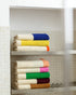 Soft brown and lime bathroom towel from Suite 702 with a textured fabric, ideal for drying hands or face.