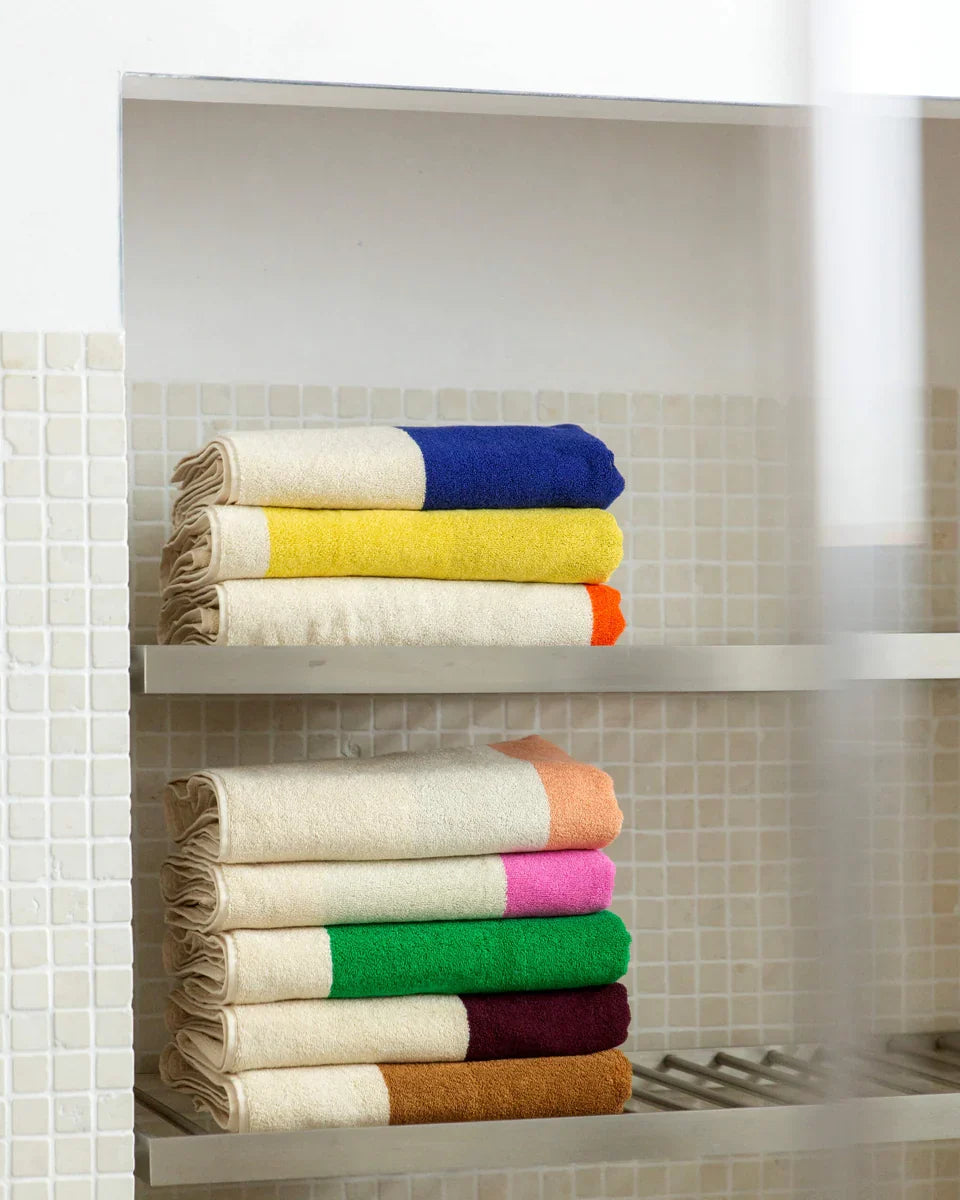 Soft brown and lime bathroom towel from Suite 702 with a textured fabric, ideal for drying hands or face.