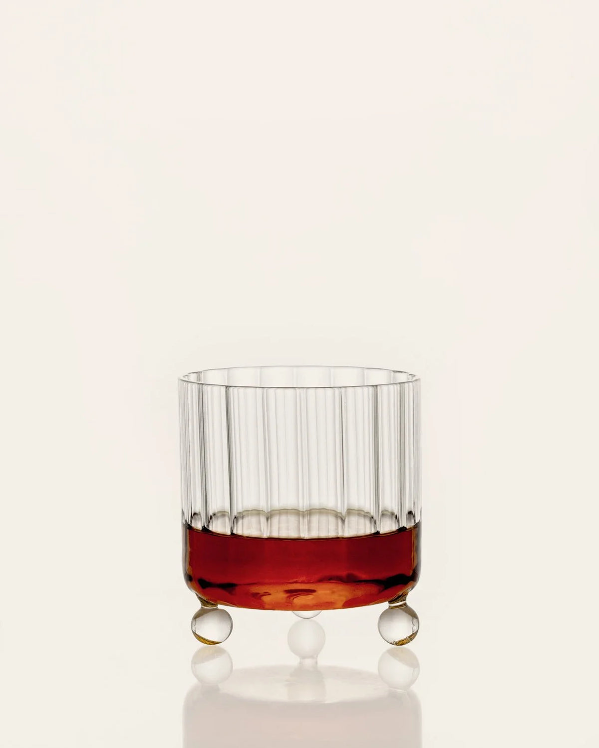High Spirits lowball glass with ribbed body and three spherical supports
