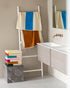 Aqua-colored bath towel by Suite 702, 70x140 inches, displayed folded on a neutral background.