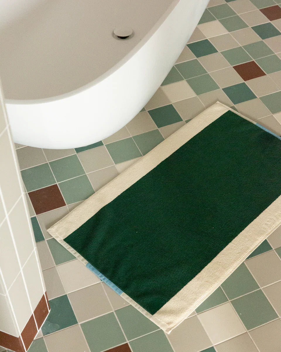 Dark green bath mat from Suite 702 in aqua color, 50x80 inches, showing soft plush fabric and textured surface.