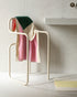 Dark green and pink Suite 702 bath towel, 70x140 inches, displayed folded with soft, plush fabric texture.