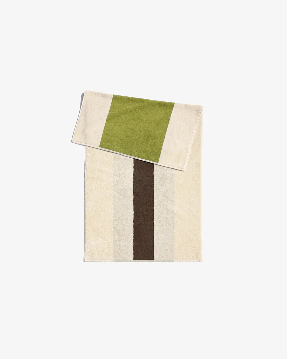 Brown towel from Suite 702 with lime accents, showing soft fabric texture and folded neatly for display.