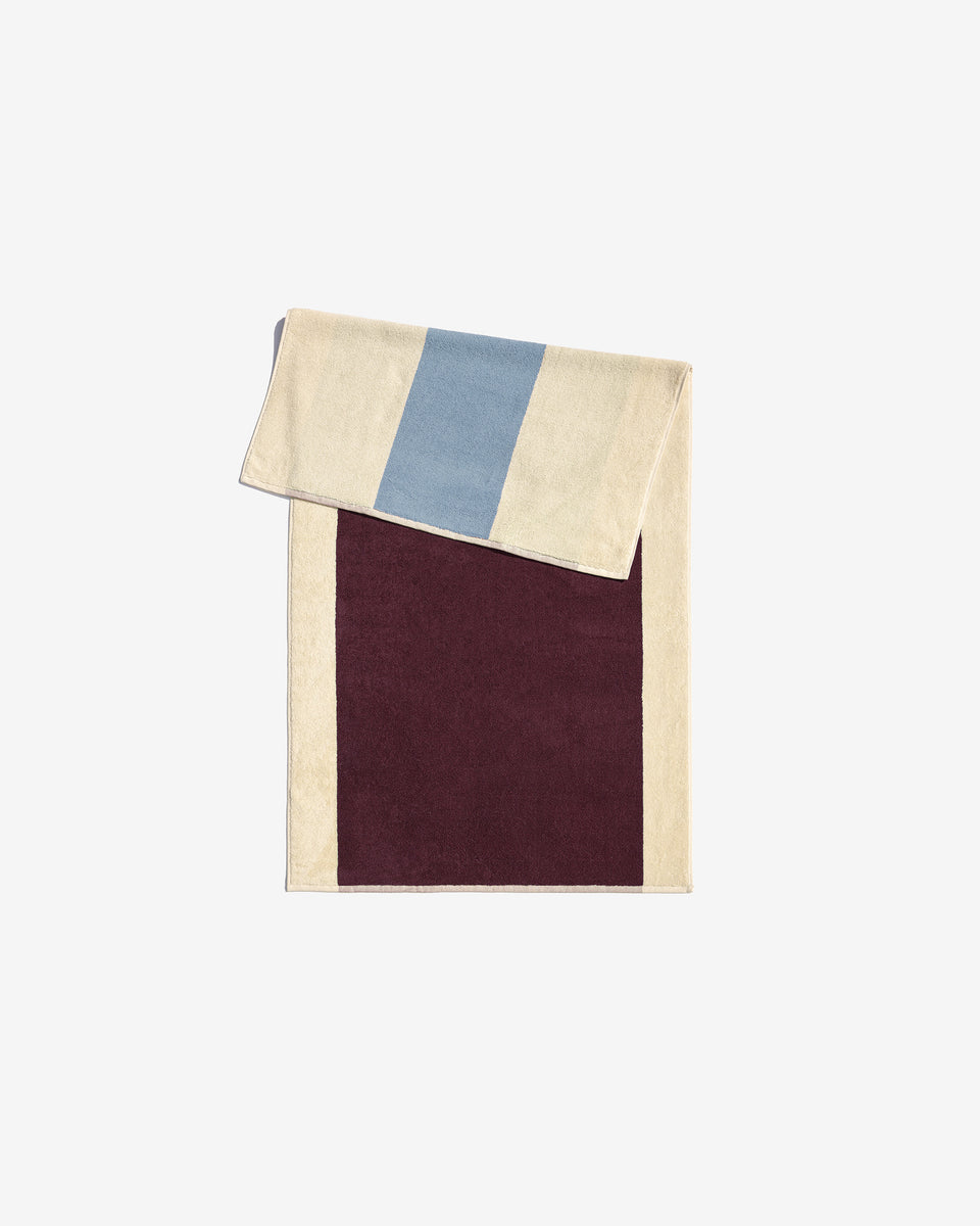Sky blue Bordeaux towel by Suite 702, showing soft fabric and vibrant color, perfect for bath or beach use.