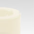Close-up of the corner of a smooth vanilla white bowl on a light gray background