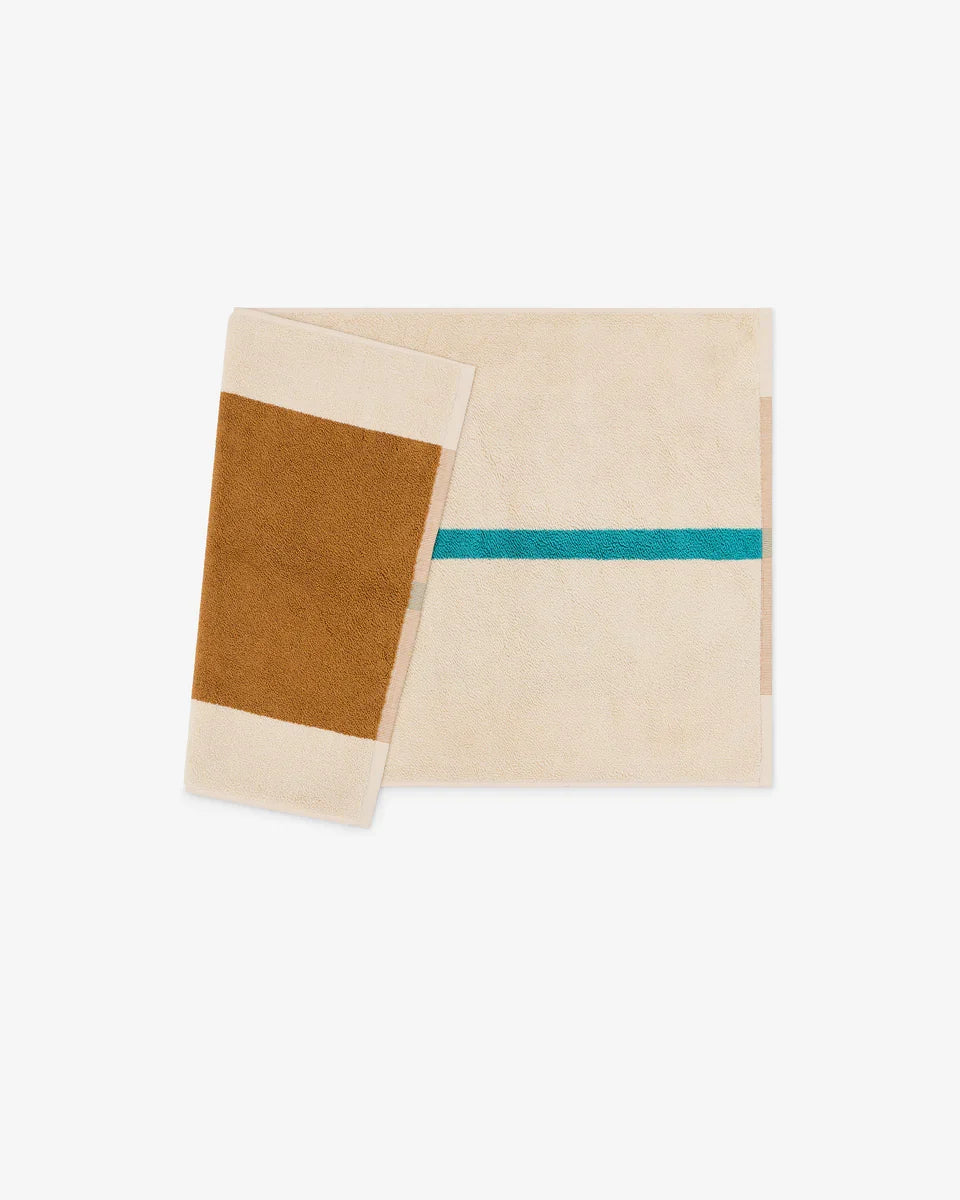 Turquoise and toffee bath mat from Suite 702, 50x80 inches, featuring soft, plush fabric for comfort and style in the bathroom.