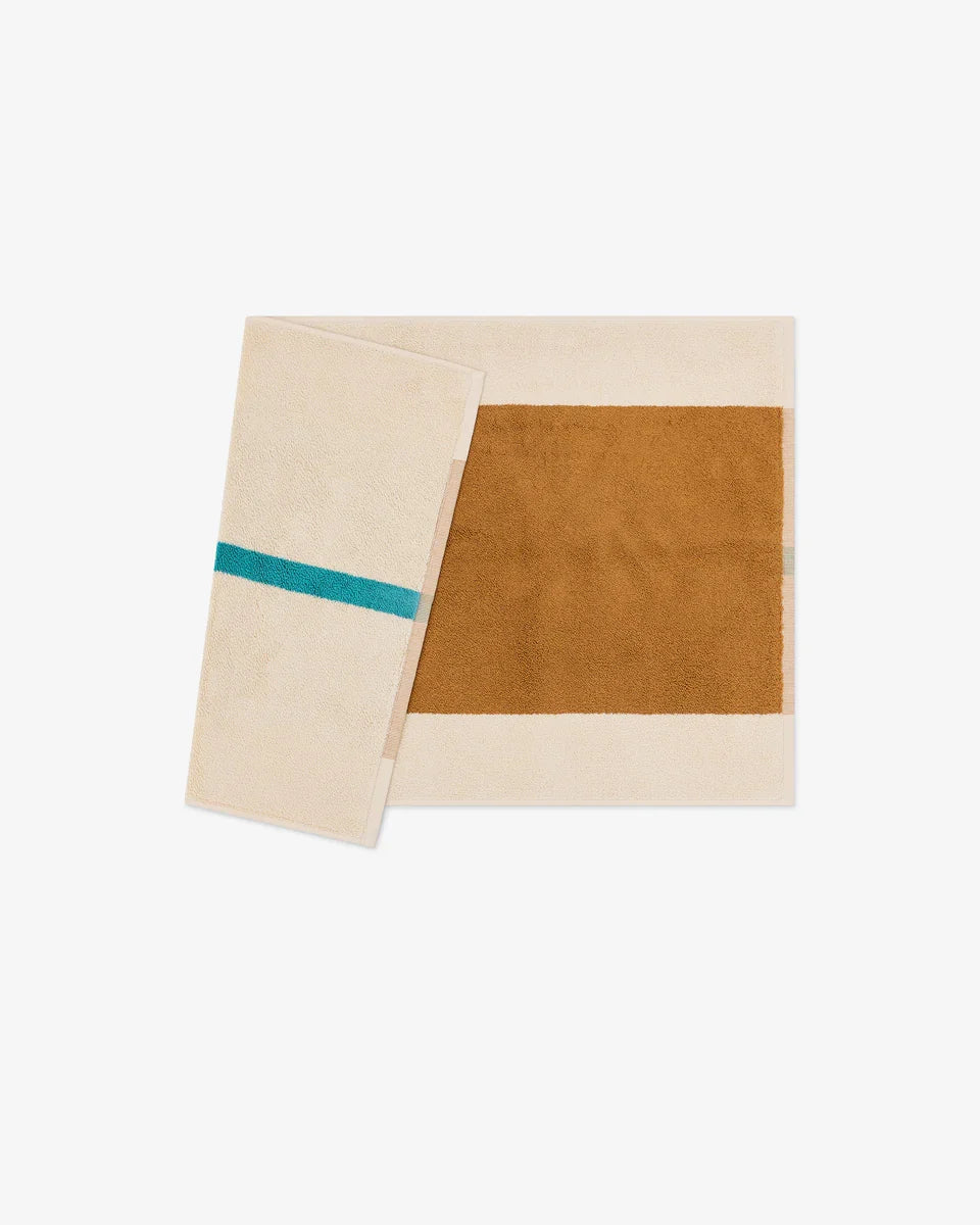 Turquoise and toffee bath mat from Suite 702, 50x80 inches, soft and plush bath towel with a textured surface.