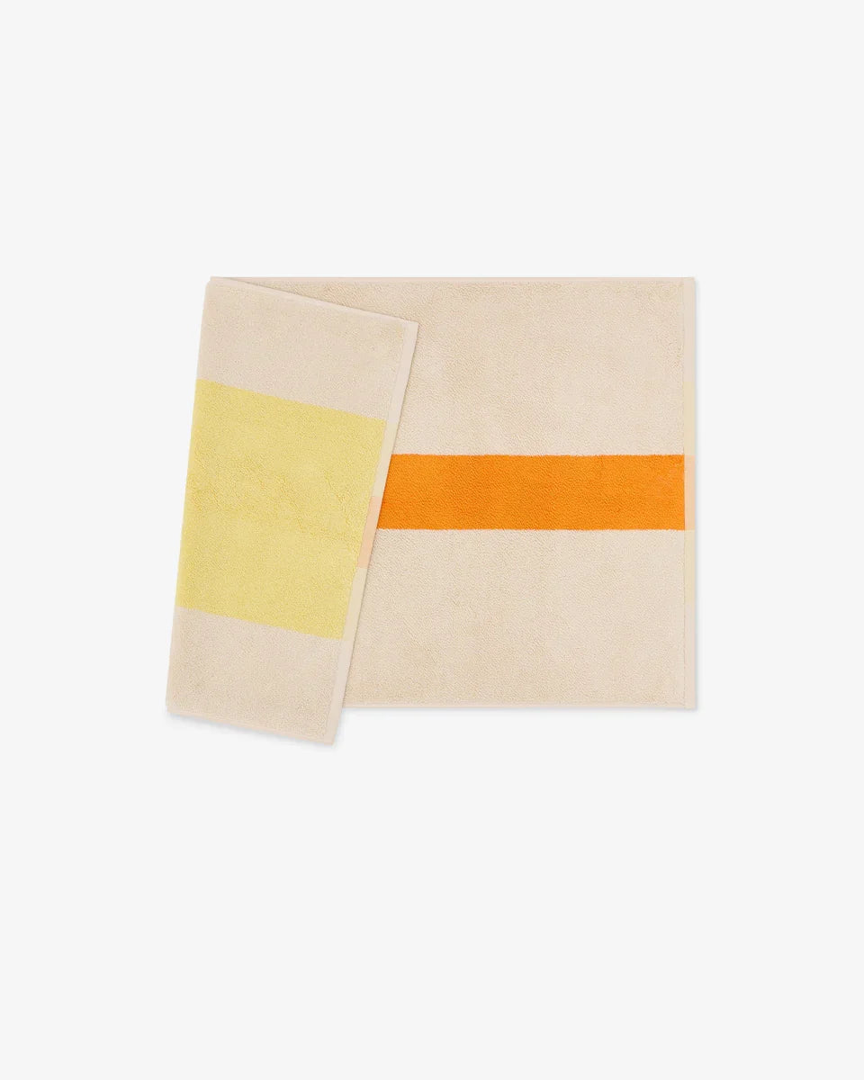 Yellow and orange bath mat from Suite 702, 50x80 inches, with soft textured surface for bathroom decor and comfort.