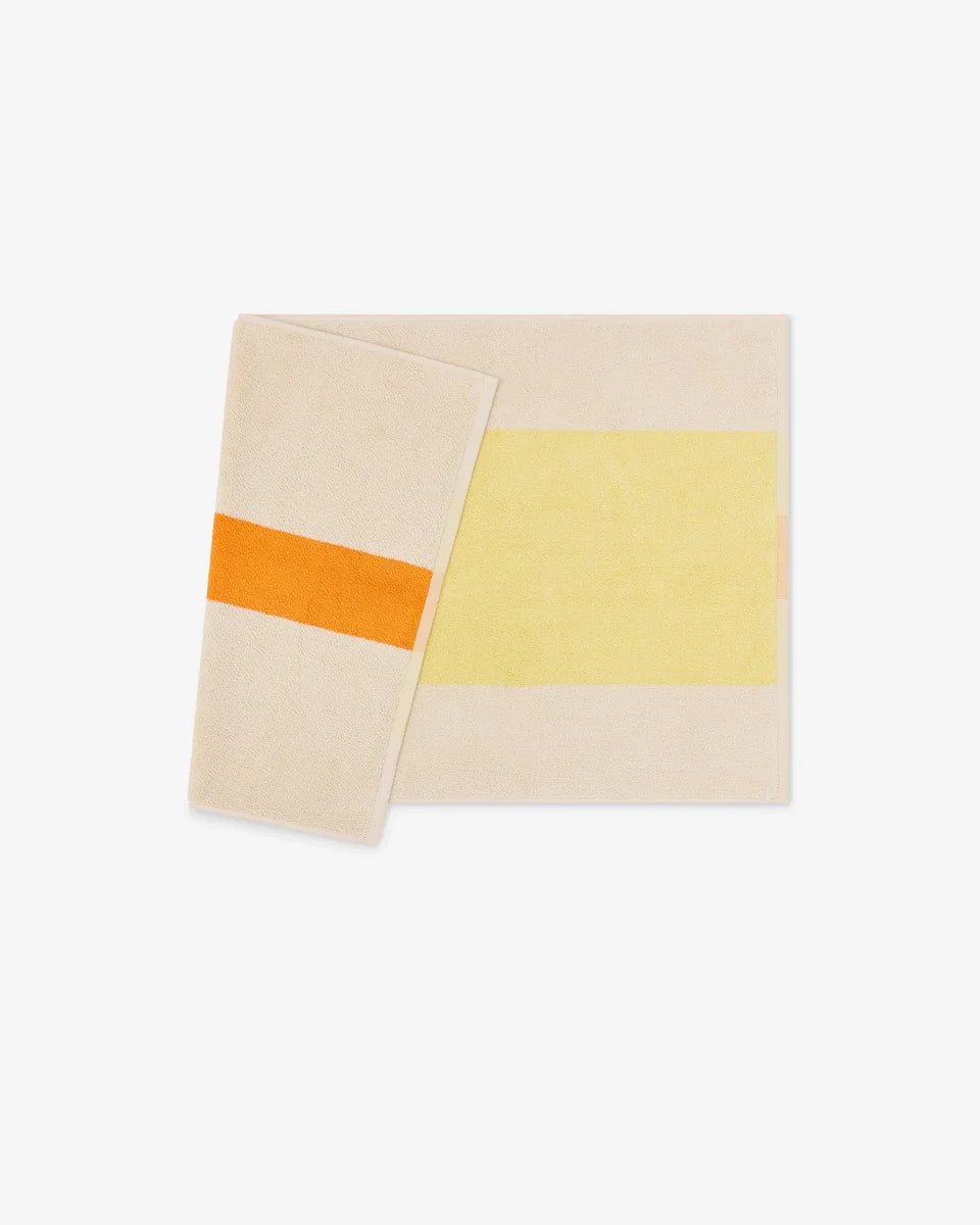 Yellow and orange bath mat by Suite 702, 50x80 inches, featuring a plush, textured surface for bathroom comfort and style.