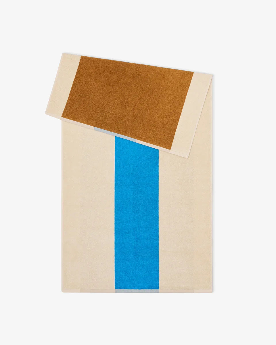 Aqua and toffee-colored bath towel from Suite 702, 70x140 inches, showing soft fabric and folded design.