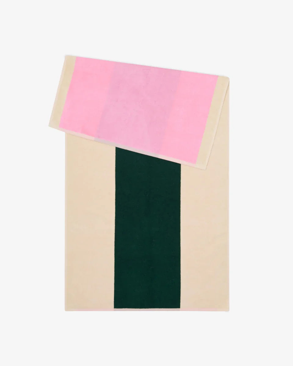 Pink and dark green bath towel from Suite 702, 70x140 inches, showing soft fabric and vibrant color details.