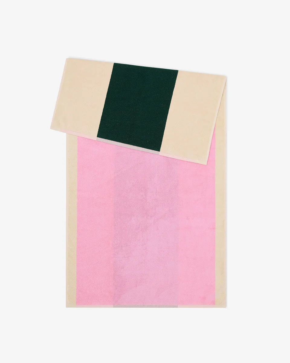 Pink and dark green bath towel from Suite 702, 70x140 inches, soft and absorbent, shown folded with vibrant colors.