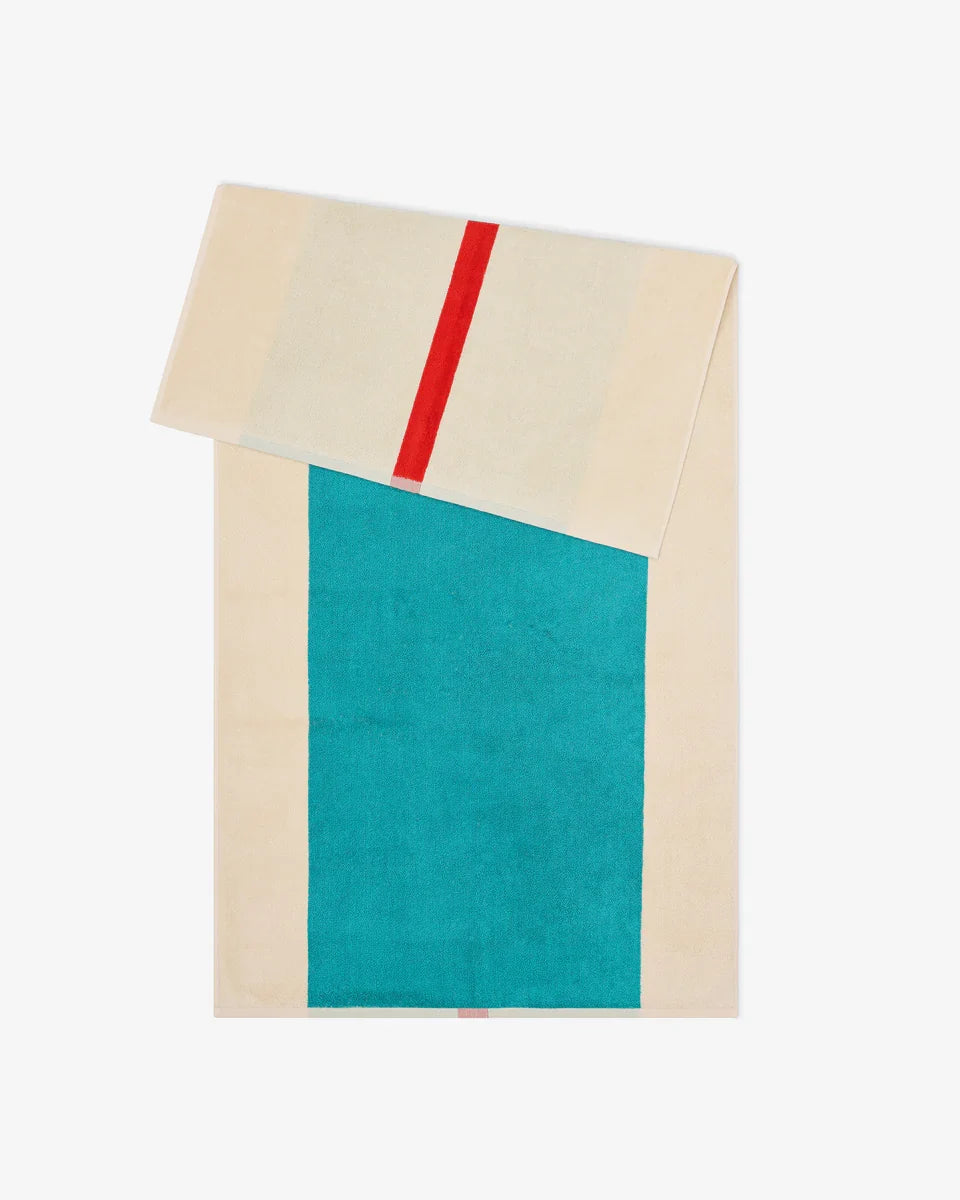 Red and turquoise Suite 702 bath towel, 70x140 inches, showing soft, plush fabric with a colorful striped design.