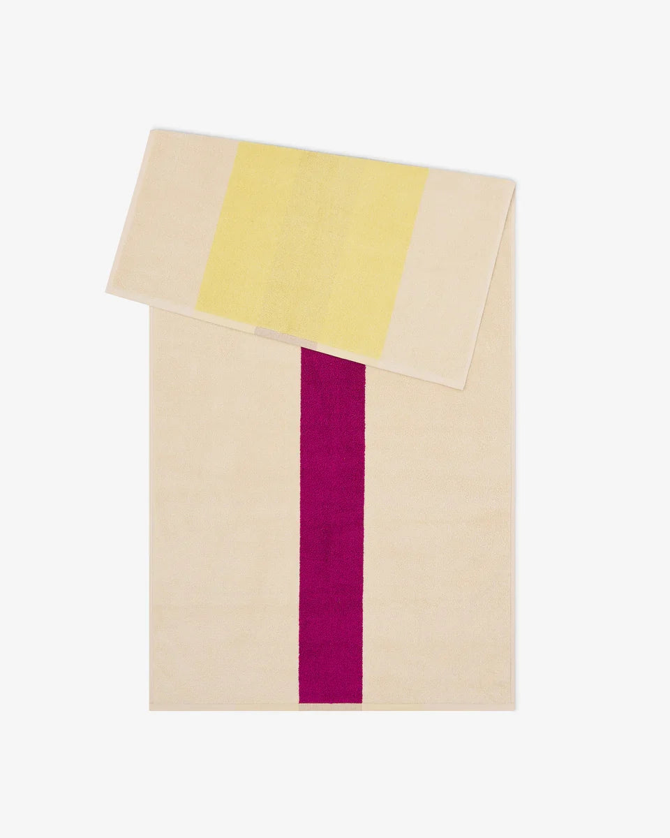 Yellow and fuchsia bath towel from Suite 702, 70x140 inches, showing soft, plush fabric with colorful stripes.