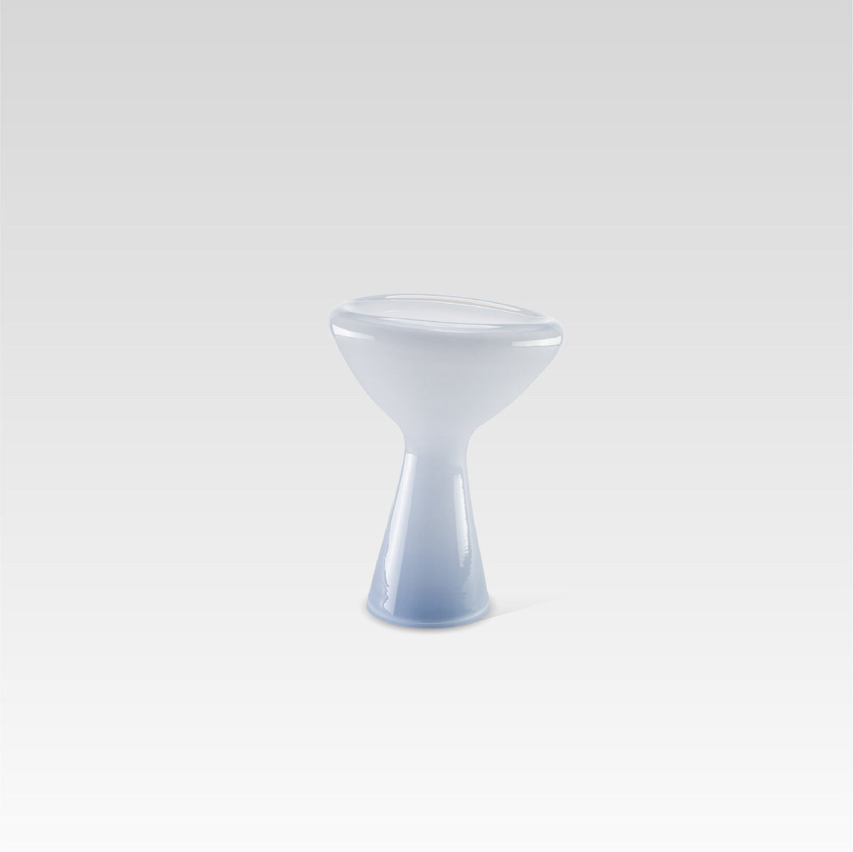 A unique, soft blue glass serving dish with an irregular shape, designed for serving snacks or desserts or as a decorative centerpiece.