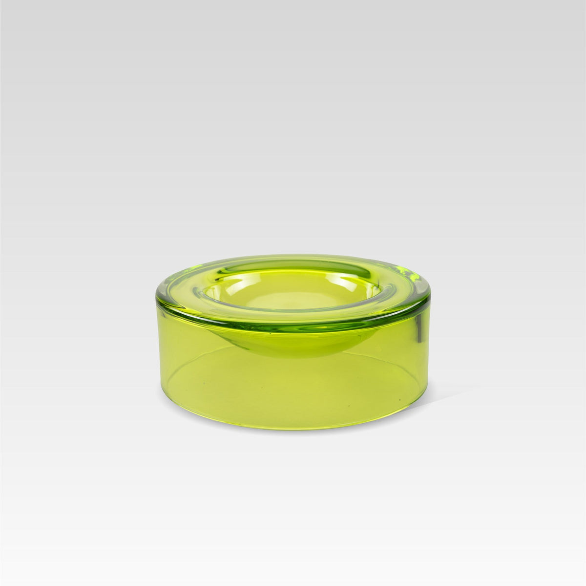 A medium-sized, lime green glass bowl designed to appear as if it is floating on the surface.