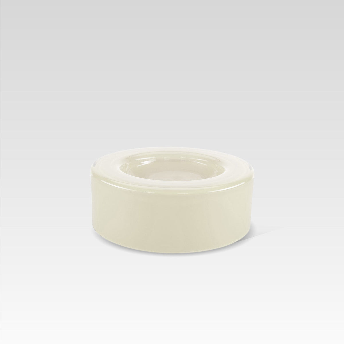 A medium-sized, handmade vanilla white glass bowl with a curved shape, displayed against a neutral background.